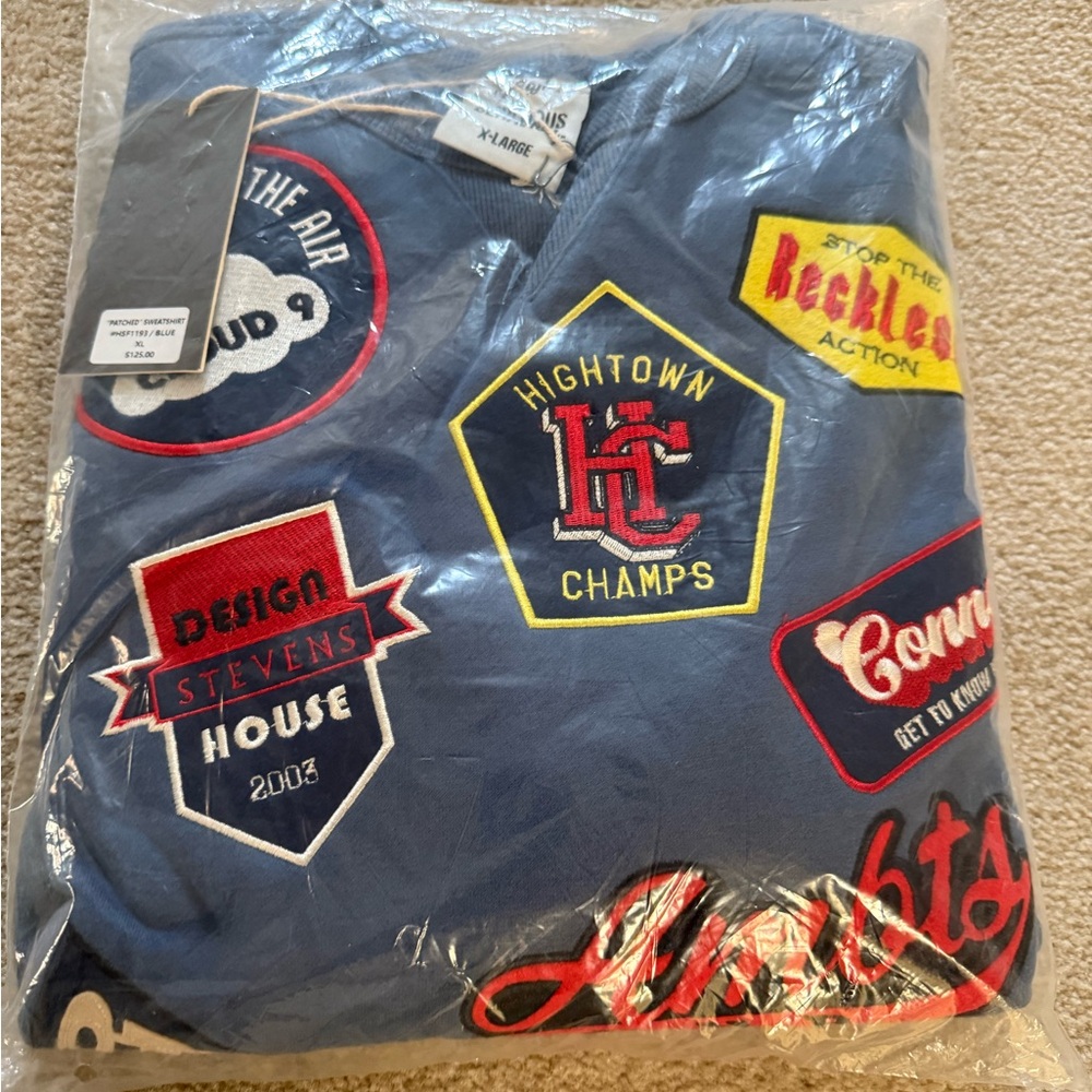 Blue sweatshirt with colorful patches
